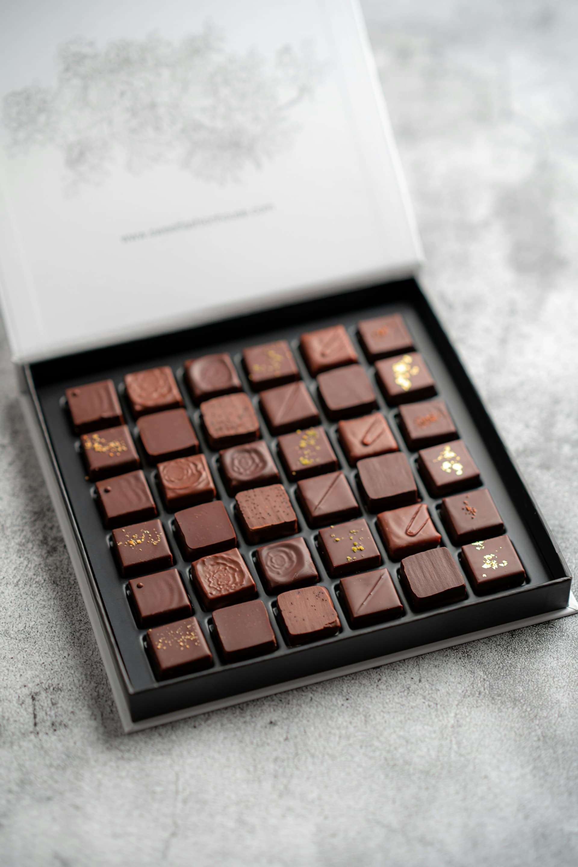 The signature box, open, showing rows of hand-finished pralines